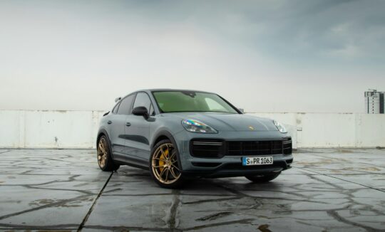 A sliver Porsche Cayenne is parking